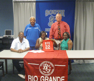 Surrounded by her parents and coaches, Columbus South's Keyvona Waddell shows off her jersey after signing with Rio Grande